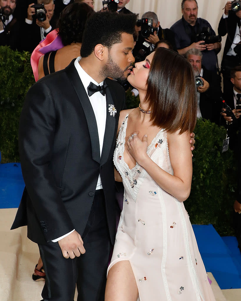 The Weeknd kisses Selena Gomez at 