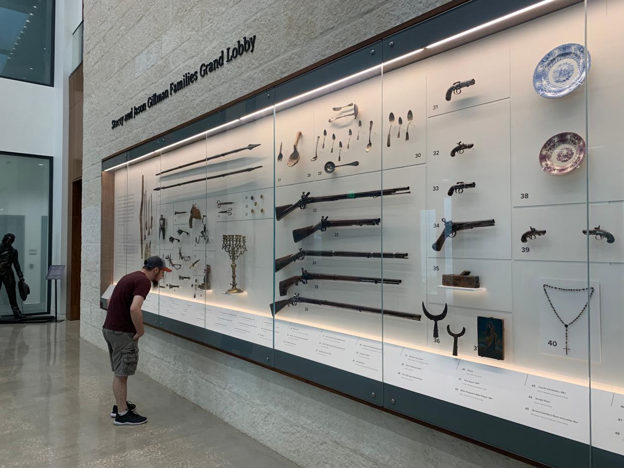 The tricentennial of the Alamo's move to its current site will be celebrated in 2024. Here a visitor examines artifacts at the new Ralston Family Collections Center in the Alamo complex.