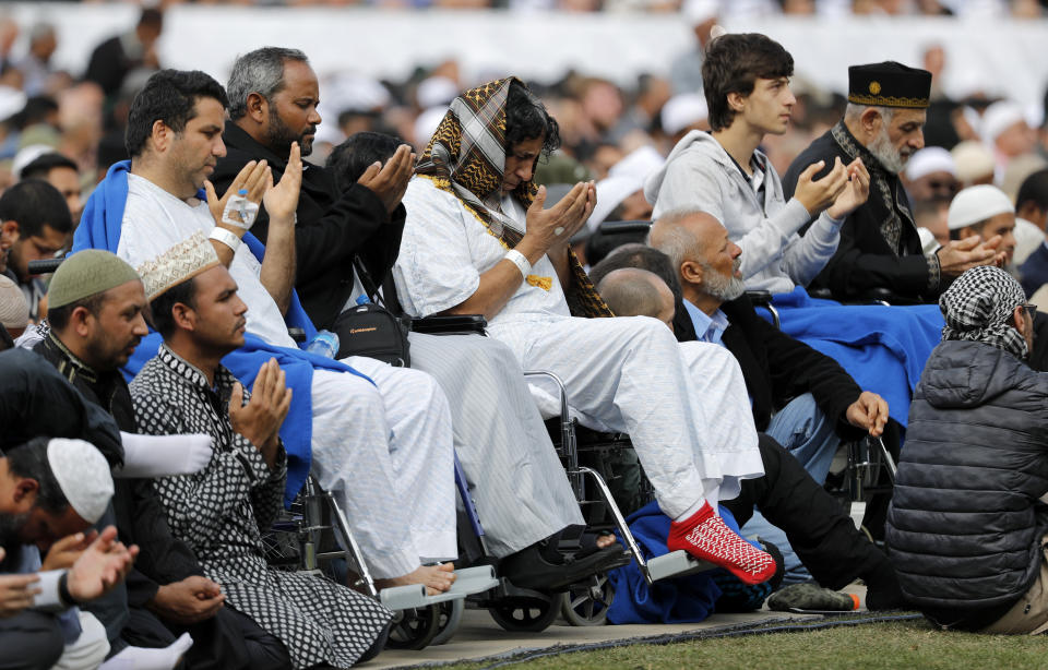 Injured victims from last week's mosque shootings pray during Friday prayers at Hagley Park in Christchurch, New Zealand, Friday, March 22, 2019. People across New Zealand observed the Muslim call to prayer Friday as the nation reflected on the moment one week ago when 50 people were slaughtered at two mosques. (AP Photo/Vincent Thian)