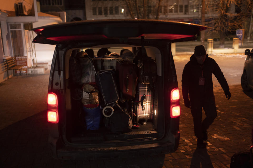 Belongings of people who just crossed the border with Russia are loaded into a vehicle before departure in Sumy, Ukraine, Thursday, Nov. 23, 2023. An average of 80-120 people return daily to Ukraine from territories held by Russia through an unofficial crossing point between the two countries amid a brutal war. Most choose this challenging path, even in freezing temperatures, to escape Russian occupation and reunite with their relatives in Ukraine. (AP Photo/Hanna Arhirova)