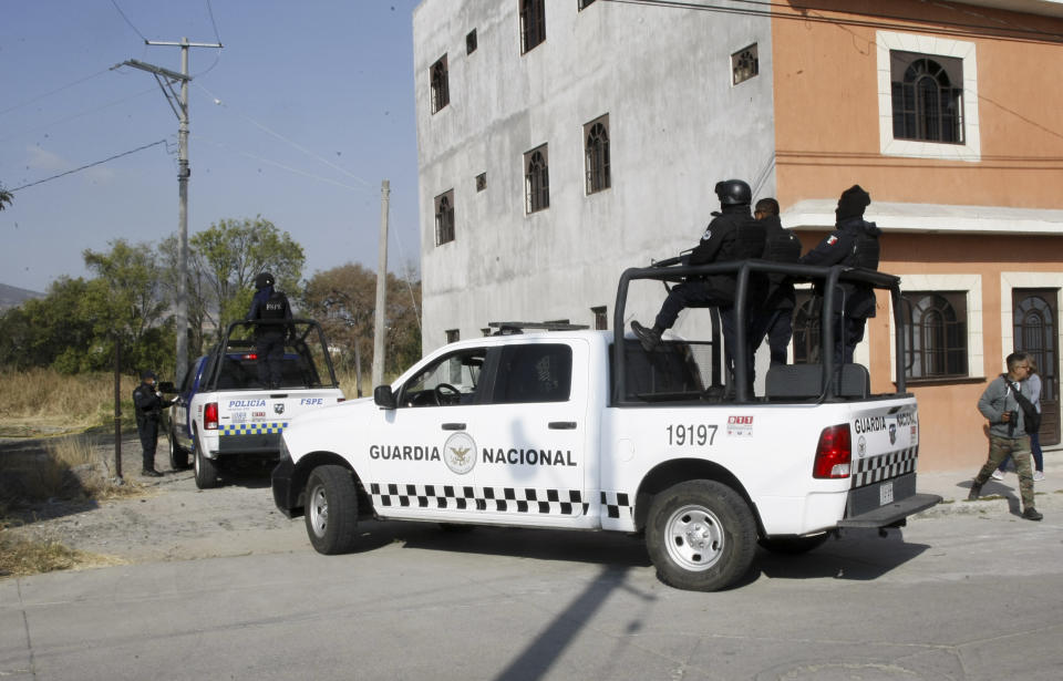 National Guard police enter the site where mass graves were found in Salvatierra, Guanajuato state, Mexico, Thursday, Oct. 29, 2020. A Mexican search group said Wednesday it has found 59 bodies in a series of clandestine burial pits in the north-central state of Guanajuato, and that more could still be excavated. (AP Photo/Mario Armas)