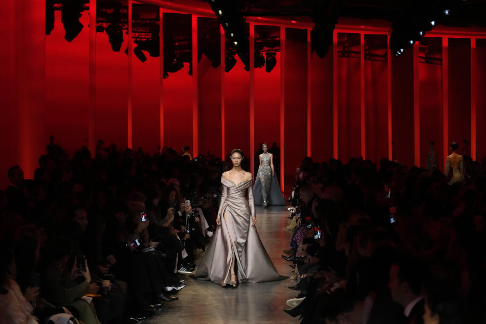 Models wear creations for Elie Saab as part of the Haute Couture Spring-Summer 2024 collection presented in Paris, Wednesday, Jan. 24, 2024. (AP Photo/Christophe Ena)