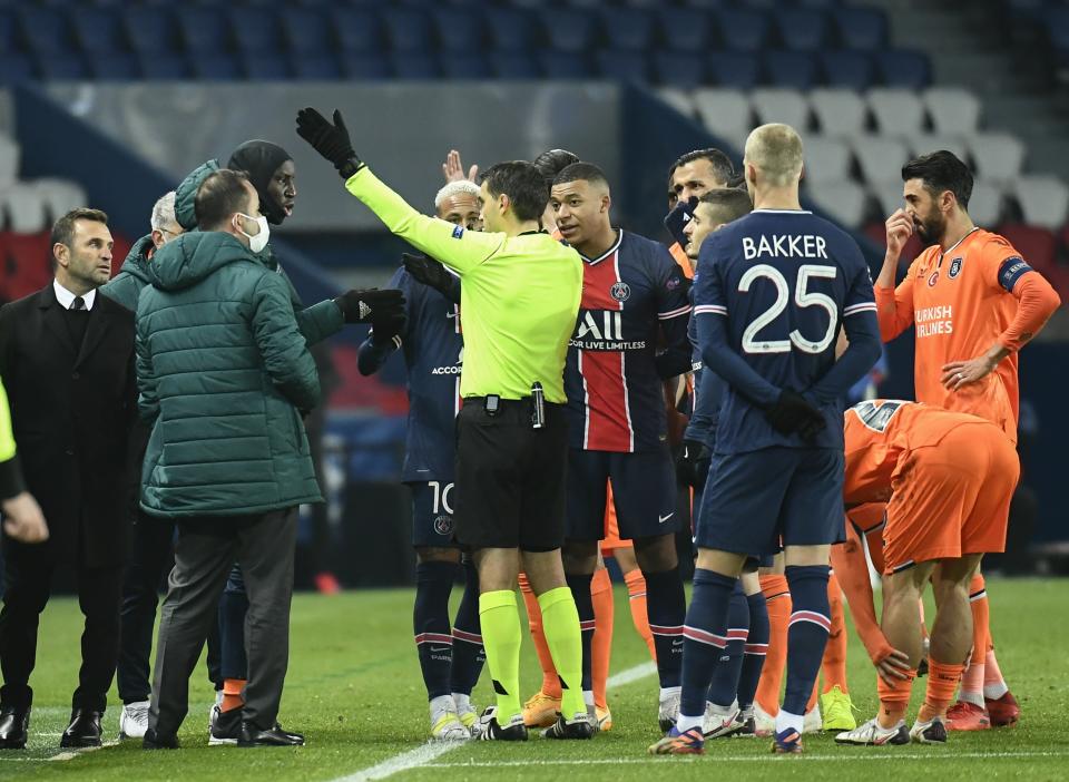 PARIS, FRANCE - DECEMBER 8: Head coach of Medipol Basaksehir Okan Buruk (L) and players are seen as Paris Saint Germain and Medipol Basaksehir UEFA Champions League match paused after Basaksehir head to locker room for alleged racist remarks by 4th official to assistant manager Webo at the Princes Park, in Paris, France on December 8, 2020. (Photo by Julien Mattia/Anadolu Agency via Getty Images)