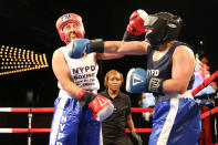 <p>New York’s police officer Selina Herrera connects with a right cross off the chin of police officer Radwa Mohammed during the NYPD Boxing Championships at the Theater at Madison Square Garden on June 8, 2017. (Photo: Gordon Donovan/Yahoo News) </p>