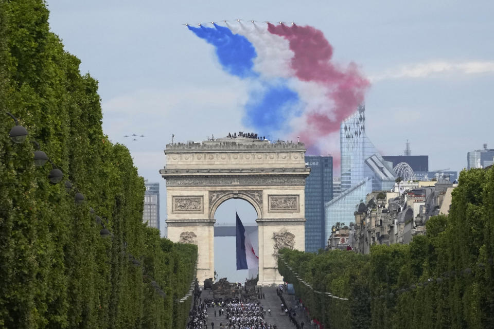 Alphajets of the Patrouille de France fly over the Champs-Elysees avenue during the Bastille Day parade, in Paris, Friday, July 14, 2023. (AP Photo/Christophe Ena)