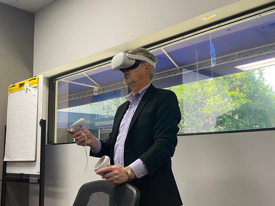 Keith Flehcher demonstrates virtual reality equipment that will be used by clients at the Goodwill of Southeast Georgia.