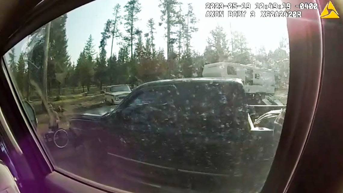 Through the window of federal agents’ vehicle, Brook Roberts can be seen holding a gun.