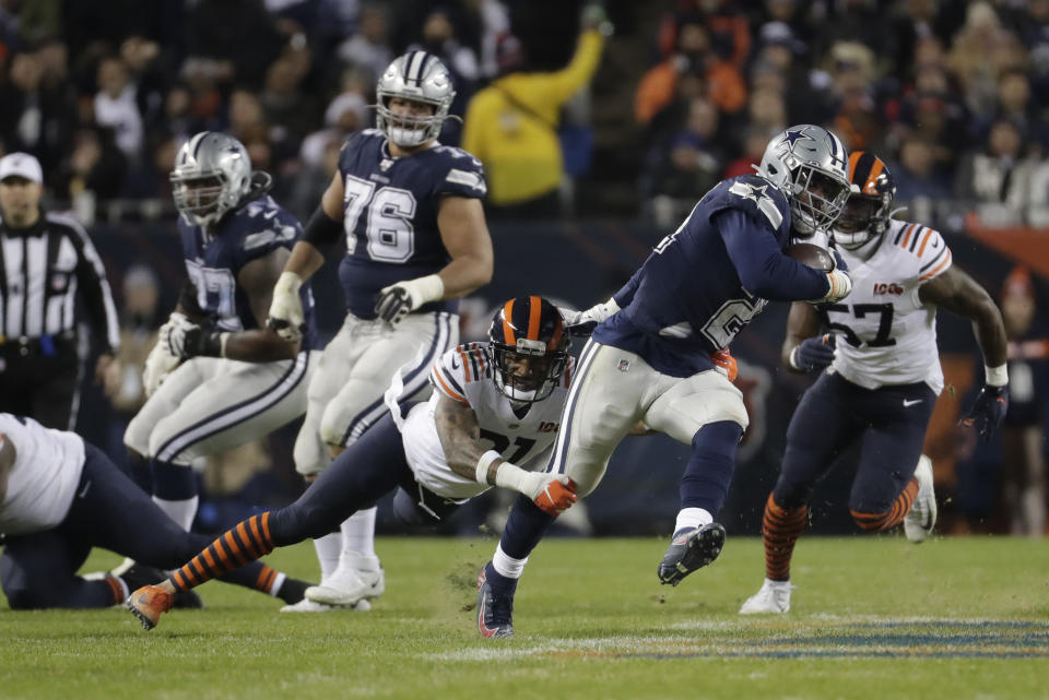 Dallas Cowboys' Ezekiel Elliott (21) runs out of a tackle of Chicago Bears' Ha Ha Clinton-Dix (21) during the first half of an NFL football game, Thursday, Dec. 5, 2019, in Chicago. (AP Photo/Morry Gash)