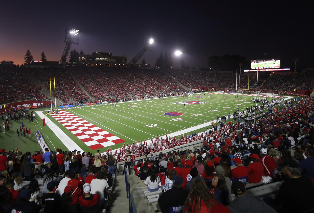 FILE - In this Nov. 9, 2019, file photo, The Bulldog Stadium is seen during the Fresno State versus Utah State game in the first half of an NCAA college football game in Fresno, Calif. This season, 39 major college football schools have scheduled 49 so-called buy games worth an estimated $65 million. If coronavirus disruptions cause Power Five teams to play more or only conference games, stretched athletic budgets could face huge holes. (AP Photo/Gary Kazanjian, File)