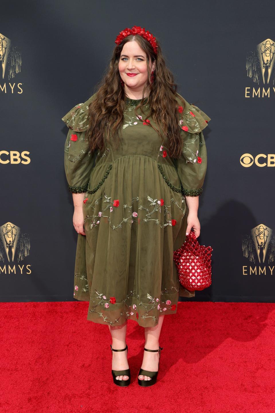 Aidy Bryant wears a green, floral dress on the Emmys red carpet.