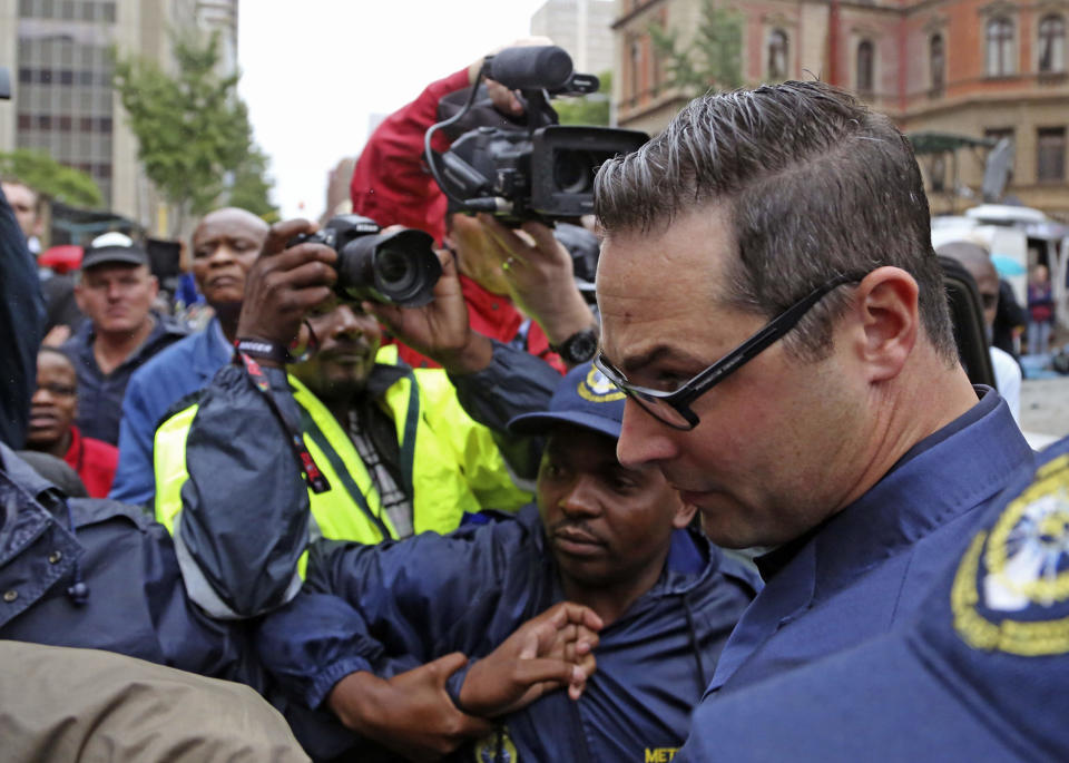 Carl Pistorius, the brother of Oscar Pistorius, arrives for his trial at the high court in Pretoria, South Africa, Monday, March 3, 2014. Oscar Pistorius is charged with murder with premeditation in the shooting death of girlfriend Reeva Steenkamp in the pre-dawn hours of Valentine's Day 2013. (AP Photo/Schalk van Zuydam)