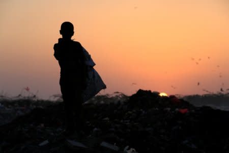 Ayoub Mohammed Ruzaiq, 11, stands in a garbage dump where he collects recyclables and food near the Red Sea port city of Hodeidah, Yemen, January 13, 2018.  REUTERS/Abduljabbar Zeyad