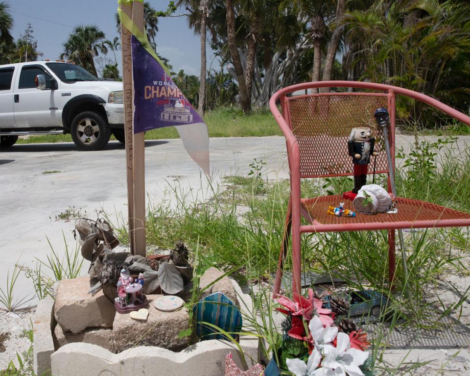 A memorial for Mitch Pacyna is seen on July 24 near where his destroyed home once stood. He died in Hurricane Ian.