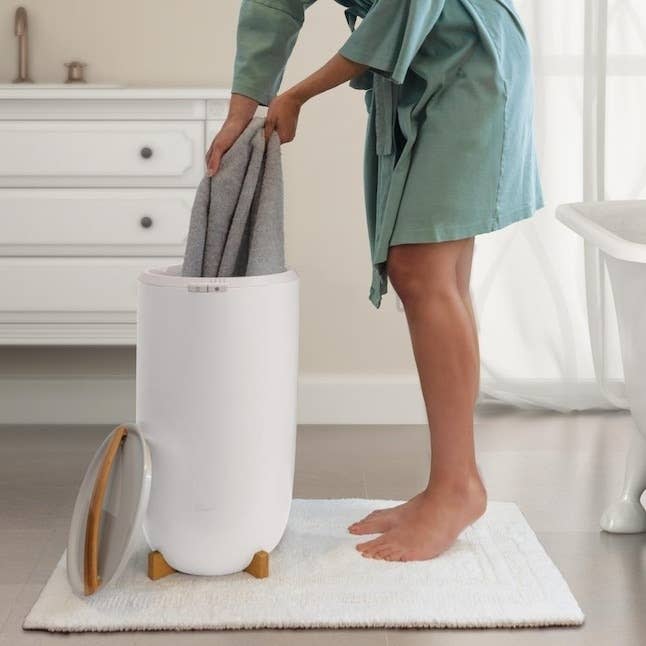 model pulling a towel from the warmer