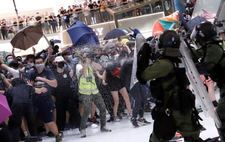 Riot police use pepper spray to disperse pro-democracy activists inside a mall after a march at Sha Tin District of East New Territories, Hong Kong