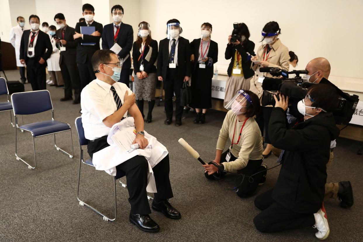 Tokyo Medical Center director Kazuhiro Araki speaks to the media after receiving a dose of the COVID-19 vaccine in Tokyo on Wednesday, Feb. 17, 2021. Japan's first coronavirus shots were given to health workers Wednesday, beginning a vaccination campaign considered crucial to holding the already delayed Tokyo Olympics.