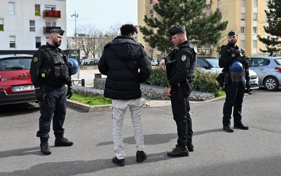 Police carry out identity checks on a street in Chenove, as part of the drugs battle