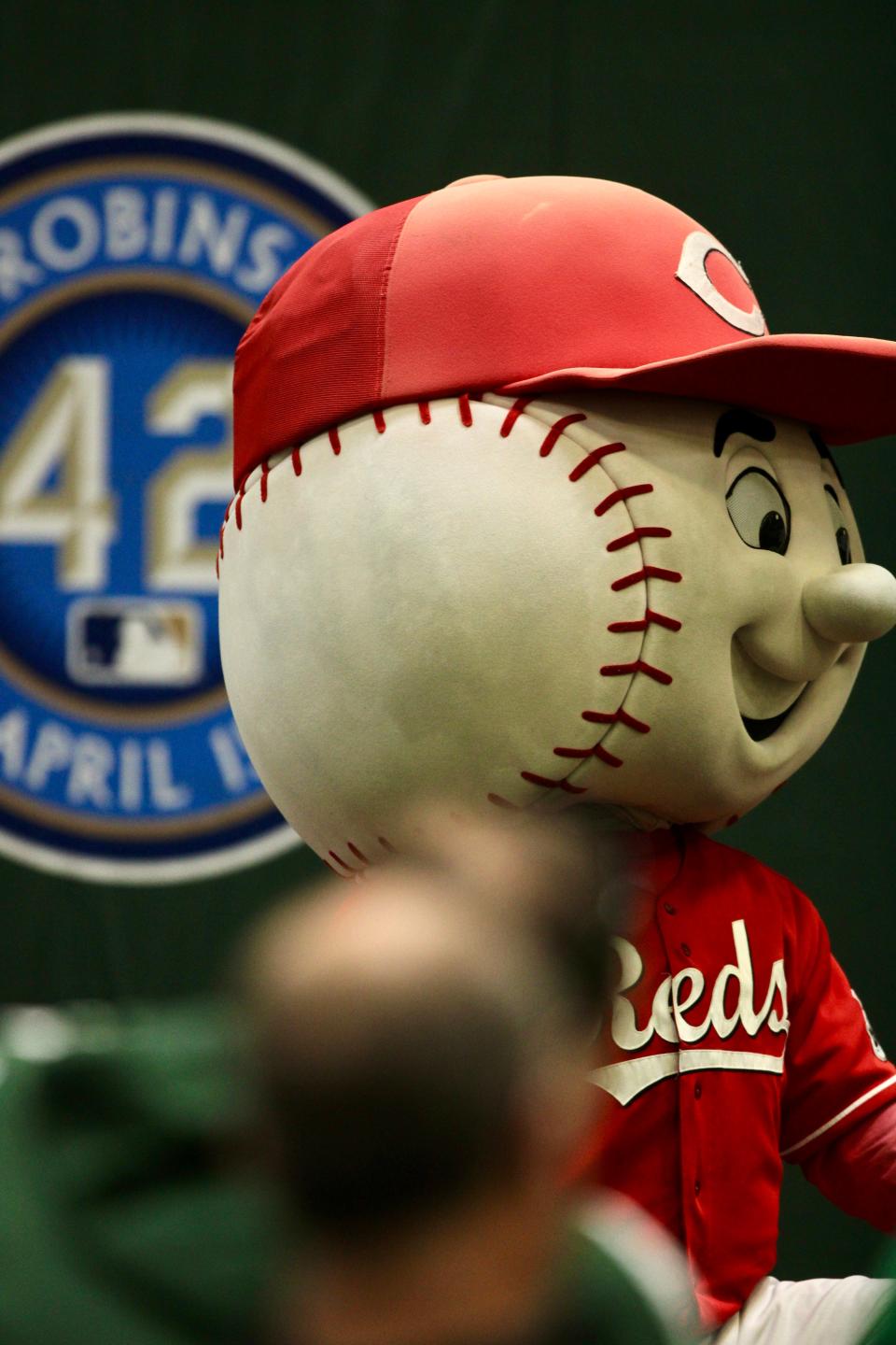 Mr. Red listens to the presentation during a reception promoting the Skyline Chili Reds Futures High School Showcase March 19, 2024 at the Reds Youth Academy.