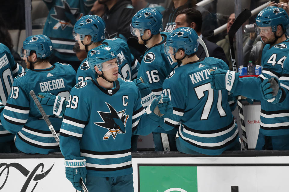 San Jose Sharks center Logan Couture (39) is congratulated for his goal against the Minnesota Wild during the second period of an NHL hockey game in San Jose, Calif., Saturday, March 11, 2023. (AP Photo/Josie Lepe)