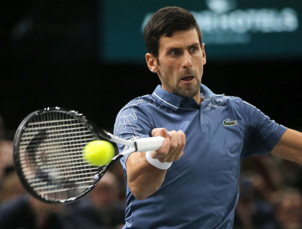 Novak Djokovic of Serbia returns the ball to Marin Cilic of Croatia during their quarterfinal match of the Paris Masters tennis tournament at the Bercy Arena in Paris, France, Friday, Nov. 2, 2018. (AP Photo/Michel Euler)