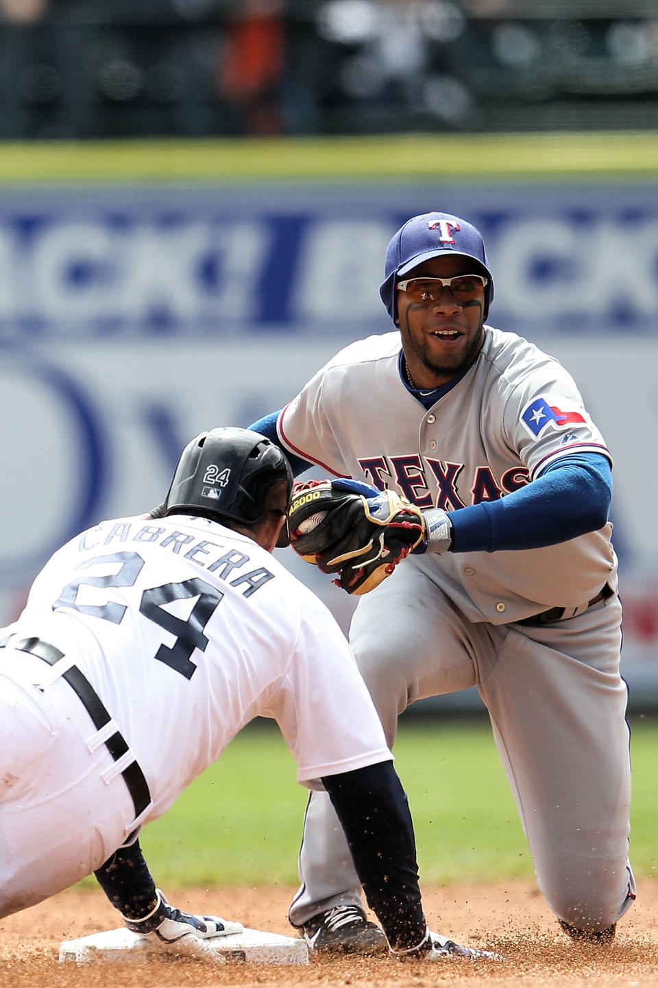 DETROIT, MI - APRIL 22: Miguel Cabrera #24 of the Detroit Tigers is tagged out at second base after stretching a single in the third inning by Elvis Andrus #1 of the Texas Rangers during the game at Comerica Park on April 22, 2012 in Detroit, Michigan. (Photo by Leon Halip/Getty Images)