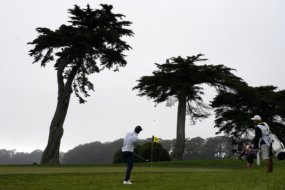 Scottie Scheffler chips to the green on the 18th hole during the third round of the PGA Championship golf tournament at TPC Harding Park Saturday, Aug. 8, 2020, in San Francisco. (AP Photo/Charlie Riedel)