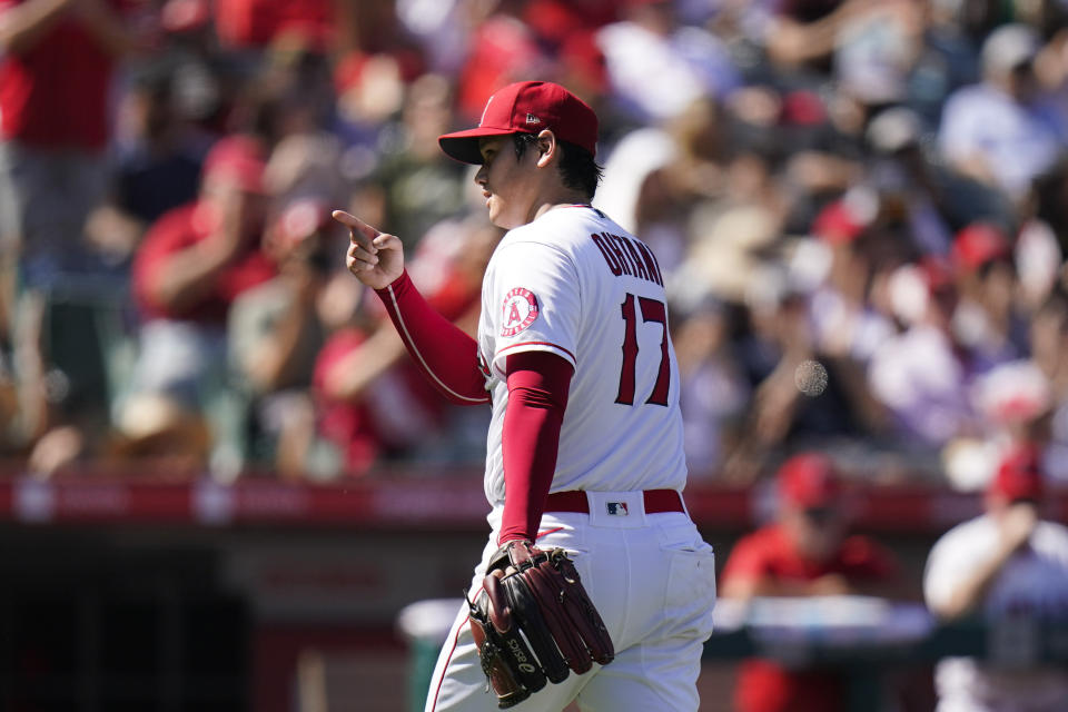 Los Angeles Angels starting pitcher Shohei Ohtani points to catcher Max Stassi after the sixth inning of a baseball game against the Oakland Athletics, Sunday, Sept. 19, 2021, in Anaheim, Calif. (AP Photo/Jae C. Hong)