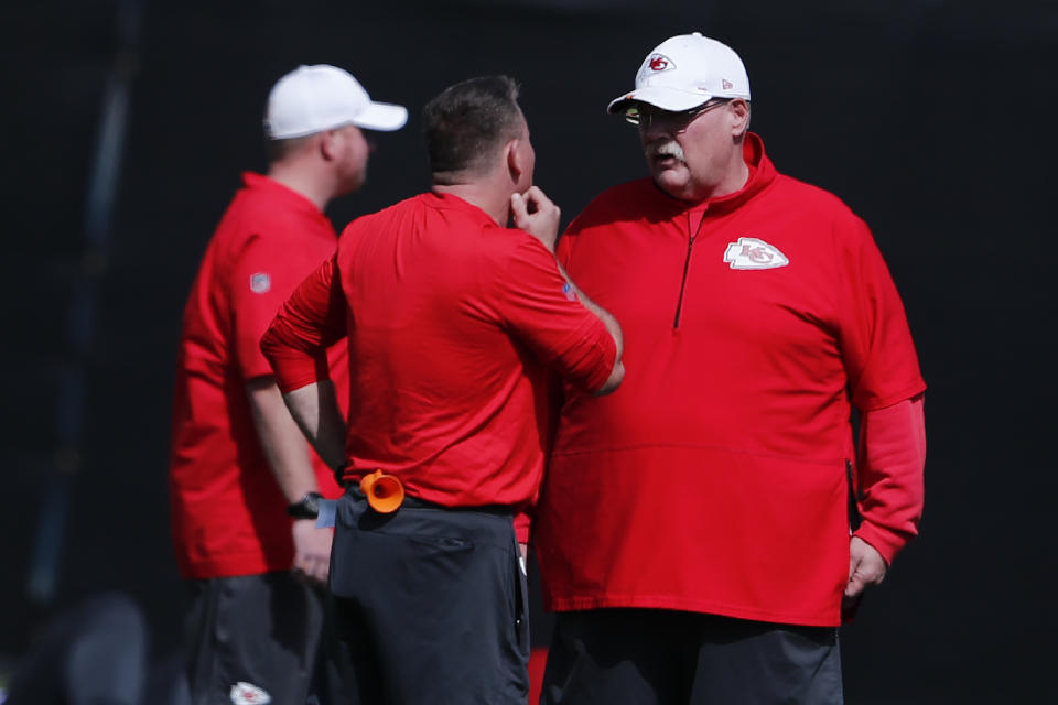 Kansas City Chiefs head coach Andy Reid, right, talks with others on the football field during practice on Thursday, Jan. 30, 2020, in Davie, Fla., for the NFL Super Bowl 54 football game. (AP Photo/Brynn Anderson)