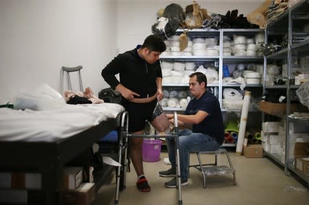 Migrants who lost legs attend a rehabilitation program