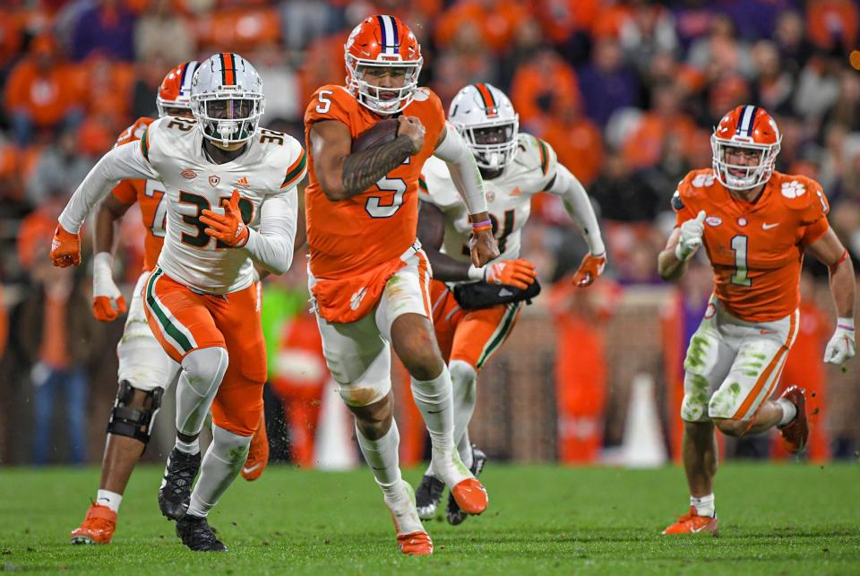 Clemson Tigers quarterback D.J. Uiagalelei (5) runs against Miami Hurricanes defensive lineman Myjalik Kelly (32) during the third quarter at Memorial Stadium Nov. 19, 2022, in Clemson, South Carolina.