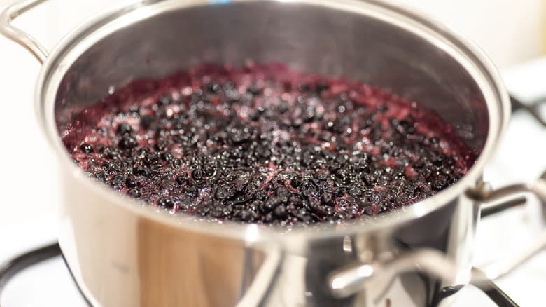 Blueberry syrup boiling on stove