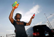<p>Thirty-three year old Eric Maurice Clark sells cold bottled drinks to drivers at a busy intersection on June 20, 2017 in Phoenix, Arizona. Record temperatures of 118 to 120 degrees were expected on Tuesday for the Phoenix-metro area. (Ralph Freso/Getty Images) </p>
