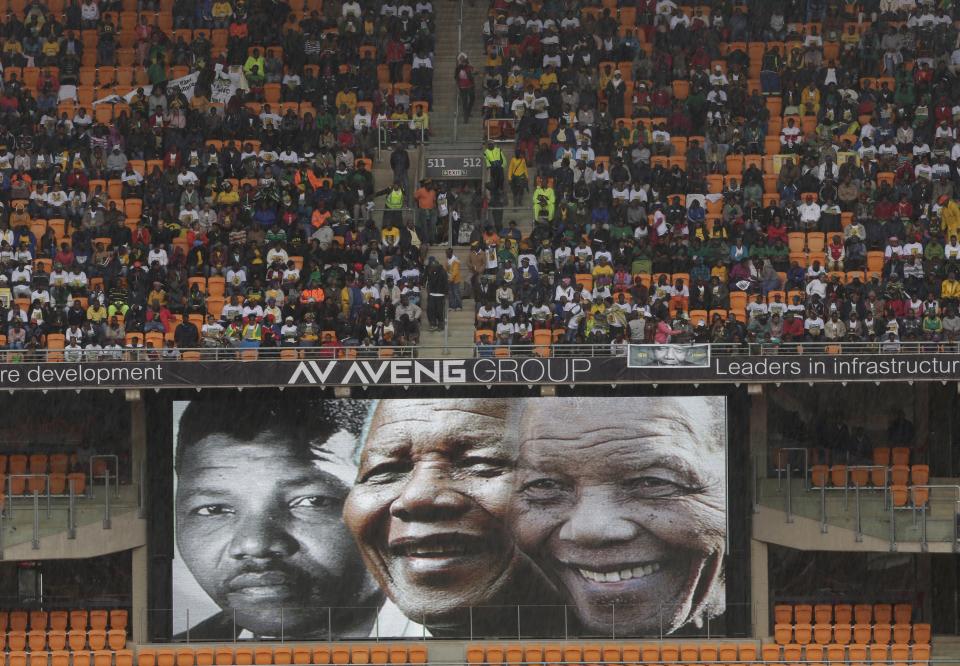 Images of Nelson Mandela though the years are flashed upon a screen during the memorial service for former South African president Nelson Mandela at the FNB Stadium in Soweto, near Johannesburg, South Africa, Tuesday Dec. 10, 2013. (AP Photo/Bernat Armangue)