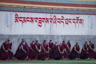 A class of monks do stretching exercises on an athletic field at the Tibetan Buddhist College near Lhasa in western China's Tibet Autonomous Region, as seen during a rare government-led tour of the region for foreign journalists, Monday, May 31, 2021. Long defined by its Buddhist culture, Tibet is facing a push for assimilation and political orthodoxy under China's ruling Communist Party. (AP Photo/Mark Schiefelbein)