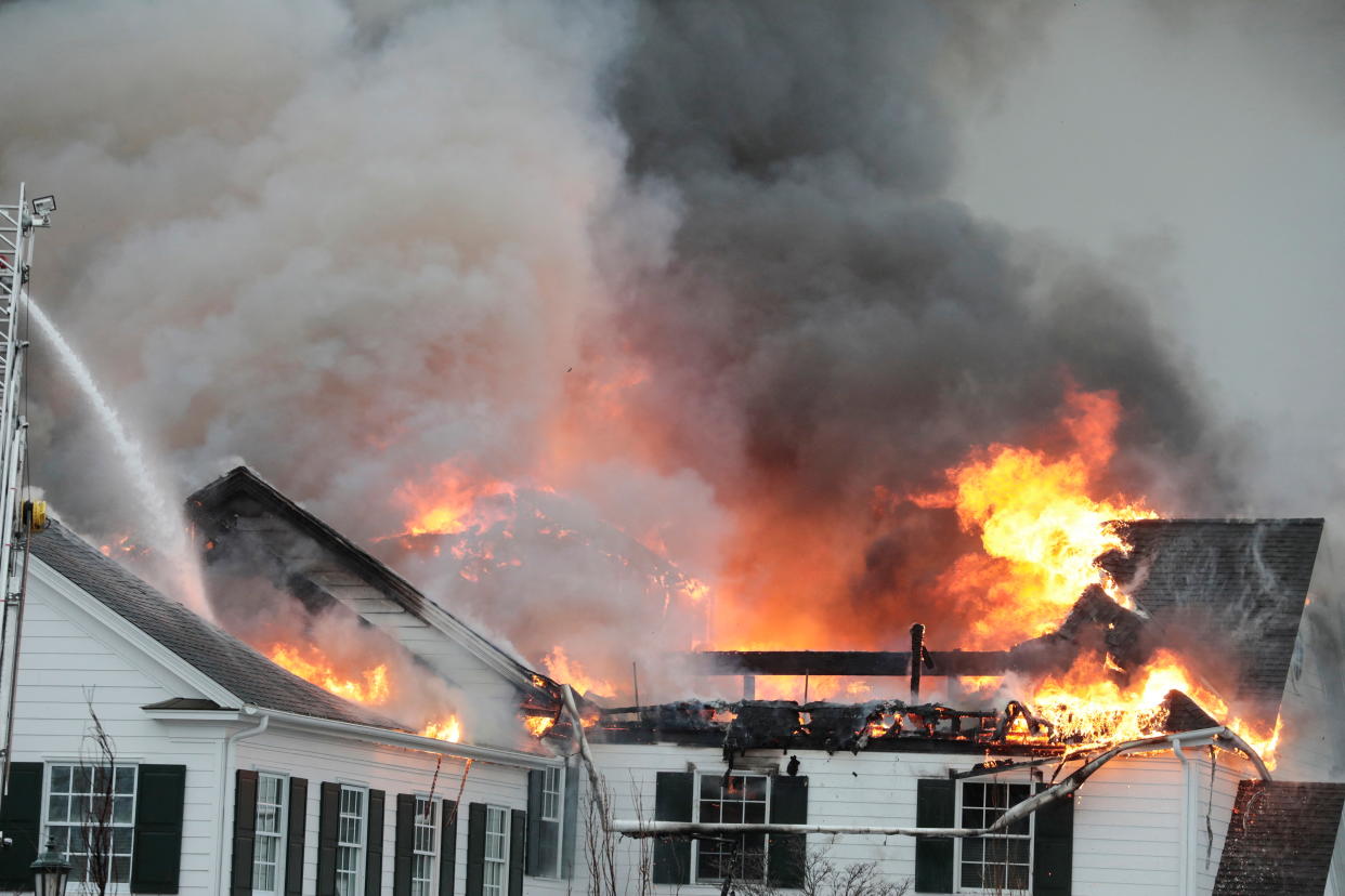 Firefighters battle a blaze that struck the Oakland Hills Country Club, which has hosted several golf majors in the past years, in Bloomfield Township, Michigan, U.S. February 17, 2022.  REUTERS/Jeff Kowalsky