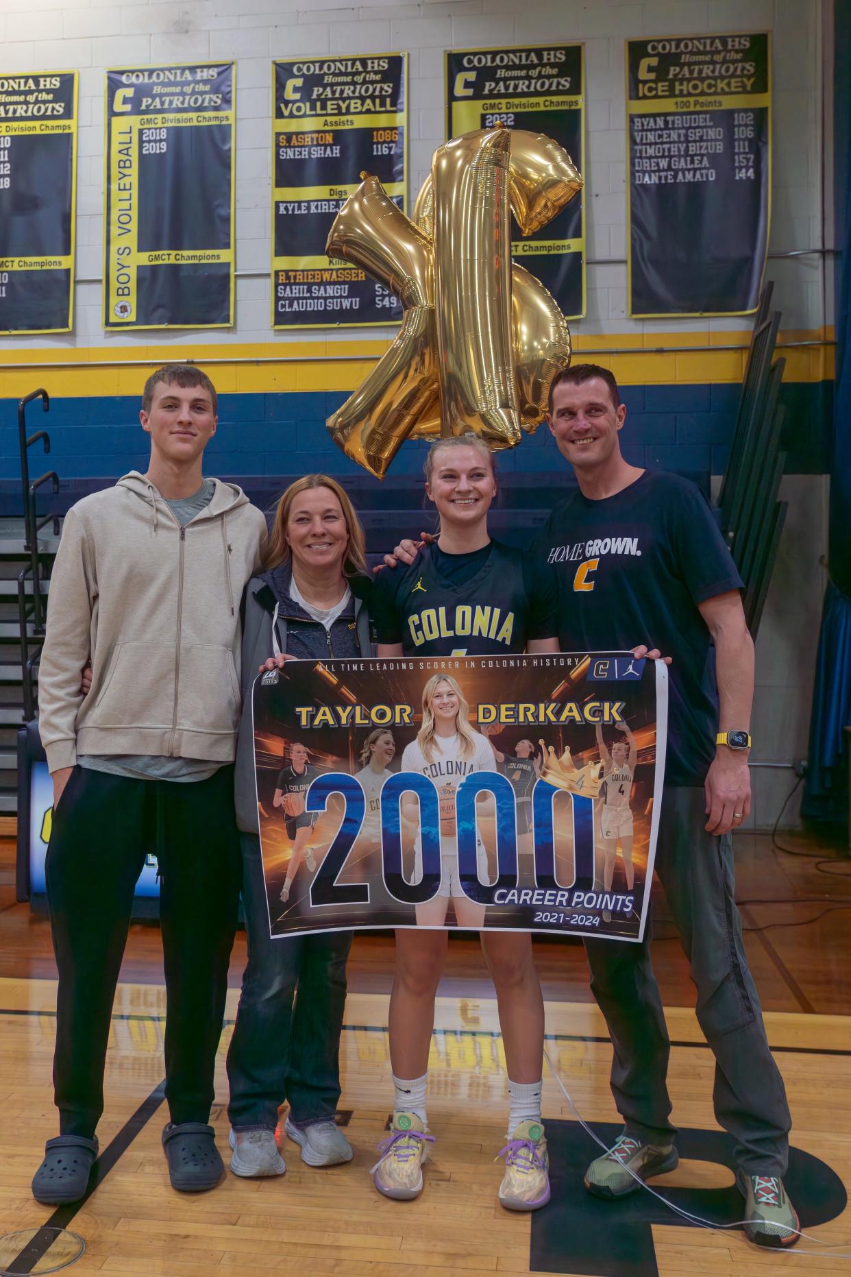 Colonia's Taylor Derkack (4) celebrates after hitting 2,000 points in a game against Belleville on Thursday, Feb. 22, 2024 night at the Colonia high school gymnasium in Colonia.