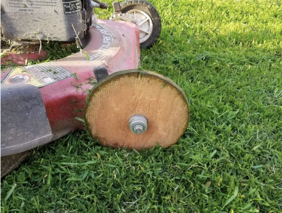 A wooden wheel on a lawnmower