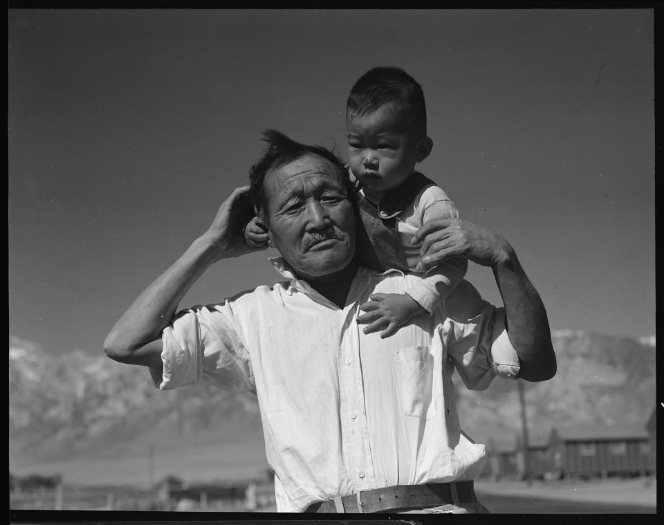 Manzanar Relocation Center, Manzanar, California. Grandfather and grandson of Japanese ancestry at this War Relocation Authority center.