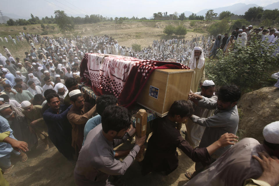 Relatives and mourners carry the casket of a victim, who was killed in Sunday's suicide bomber attack in the Bajur district of Khyber Pakhtunkhwa, Pakistan, Monday, July 31, 2023. Pakistan held funerals on Monday for victims of a massive suicide bombing that targeted a rally of a pro-Taliban cleric the previous day. (AP Photo/Mohammad Sajjad)