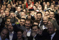 Leader of the Ordinary People and Independent Personalities party Igor Matovic poses with his supporters after acknowledging preliminary results of the general election in Trnava, Slovakia, Sunday, March 1, 2020. (AP Photo/Petr David Josek)