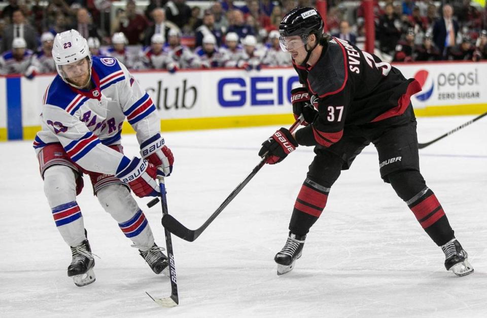 New York Rangers’ Adam Fox (23) defends Carolina Hurricanes’ Andrei Svechnikov (37) in the third period on Thursday, May 26, 2022 during game five of the Stanley Cup second round at PNC Arena in Raleigh, N.C.