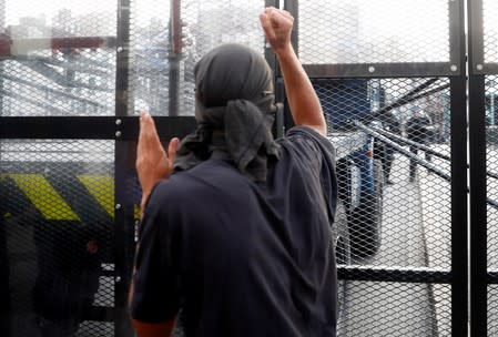 A demonstrator stands in front of the police blockade during a protest against G7 summit, in Bayonne