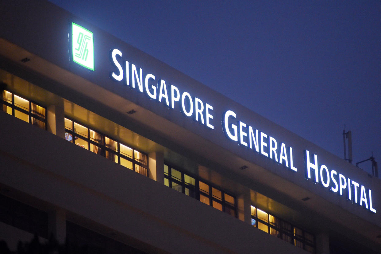 The windows of wards are seen with the sign of  Singapore General Hospital on Tuesday, Oct. 6, 2015 in Singapore.  The top public hospital in Singapore said Tuesday that four of its patients died after a new renal ward was hit by an outbreak of hepatitis C, likely from intravenous treatment. (AP Photo/Joseph Nair)