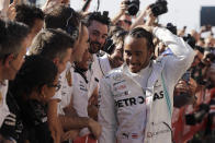 Six-time world champion Mercedes driver Lewis Hamilton, of Britain, is congratulated by his teammates after the Formula One U.S. Grand Prix auto race at the Circuit of the Americas, Sunday, Nov. 3, 2019, in Austin, Texas. (AP Photo/Darron Cummings)