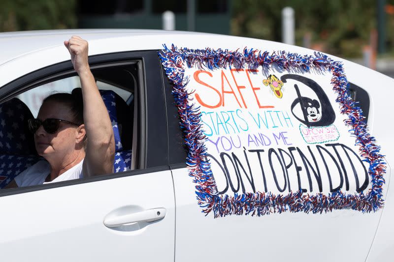 Disney cast members stage a car caravan outside Disneyland California, calling for higher safety standards for Disneyland to reopen