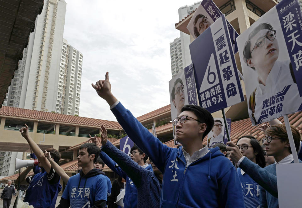 FILE - Edward Leung, center, a candidate of Hong Kong Indigenous, waves to supporters at an election rally on Feb. 28, 2016, in Hong Kong. Leung, who coined the now-banned slogan "Liberate Hong Kong, Revolution of our Times," was released from prison on Wednesday, Jan. 19, 2022, after spending four years behind bars for rioting in 2016. (AP Photo/Vincent Yu, File)