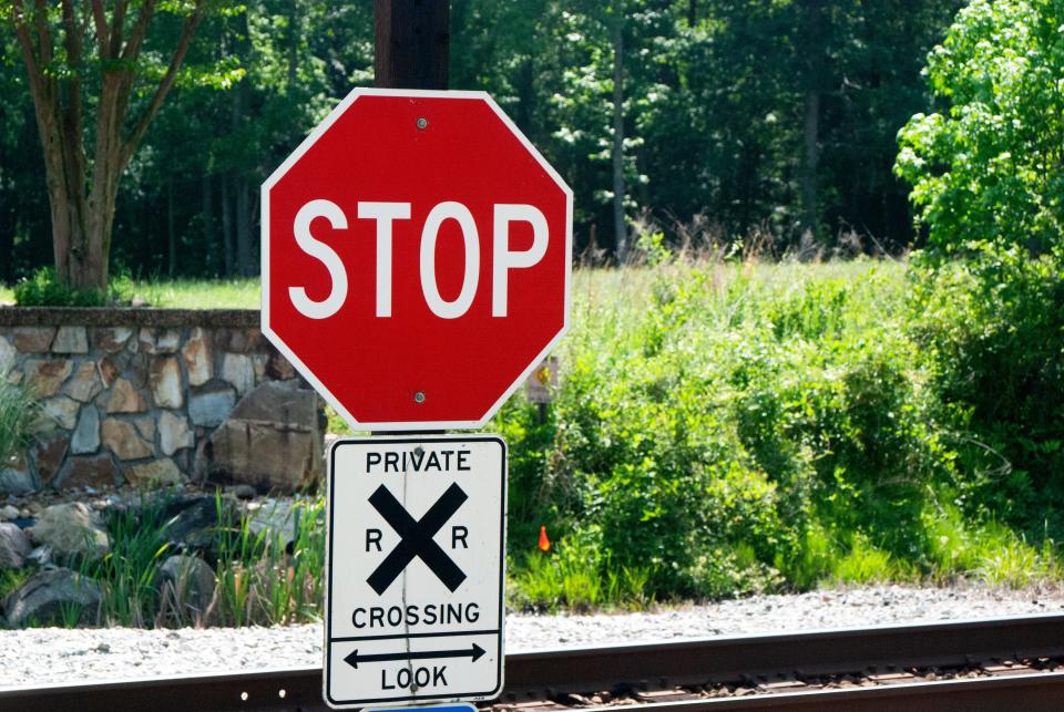 A sign reading “private crossing— look” combined with a stop sign stands at a private crossing in Lanexa, Virginia.