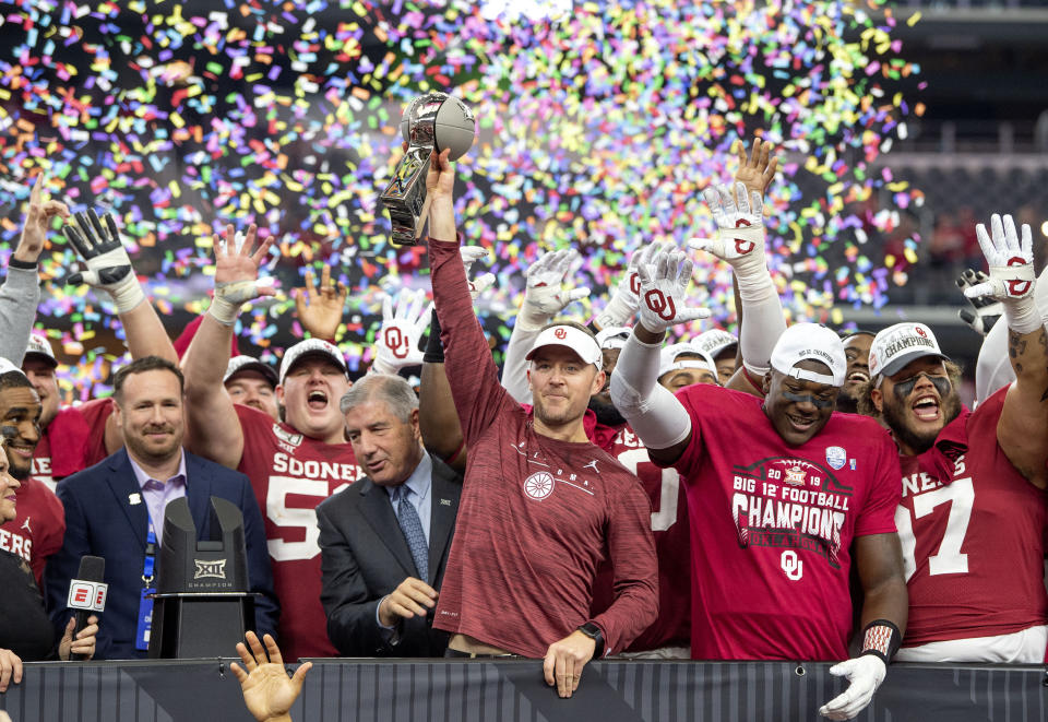 Oklahoma head coach Lincoln Riley hosts the Big 12 Conference championship trophy after defeating Baylor 30-23 in overtime in an NCAA college football game, Saturday, Dec. 7, 2019, in Arlington, Texas. (AP Photo/Jeffrey McWhorter)