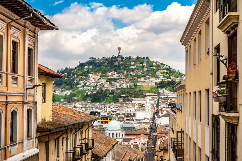 Quito, Ecuador - May 27th, 2019: View of the historical colonial district of Quito and the 45 meters tall monument of "Virgin of El Panecillo" on top of the hill overlooking downtown Quito. The monument was designed by the Spanish artist Agustín de la Herrán Matorras.