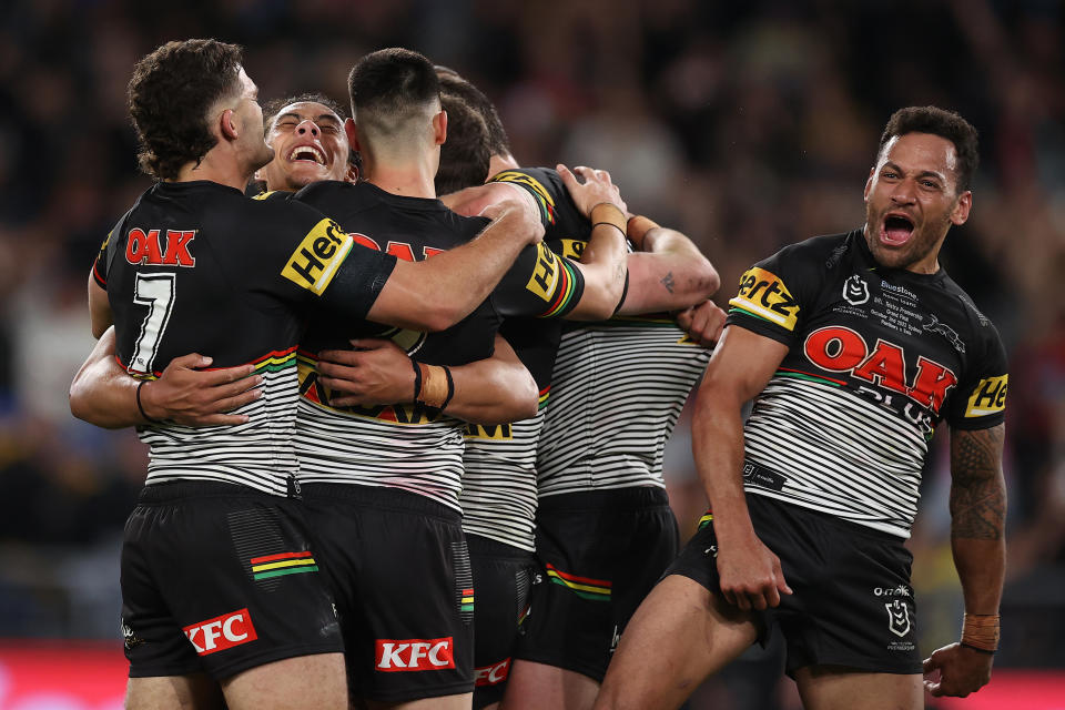 Apisai Koroisau (pictured far right) celebrates victory with the Penrith Panthers.